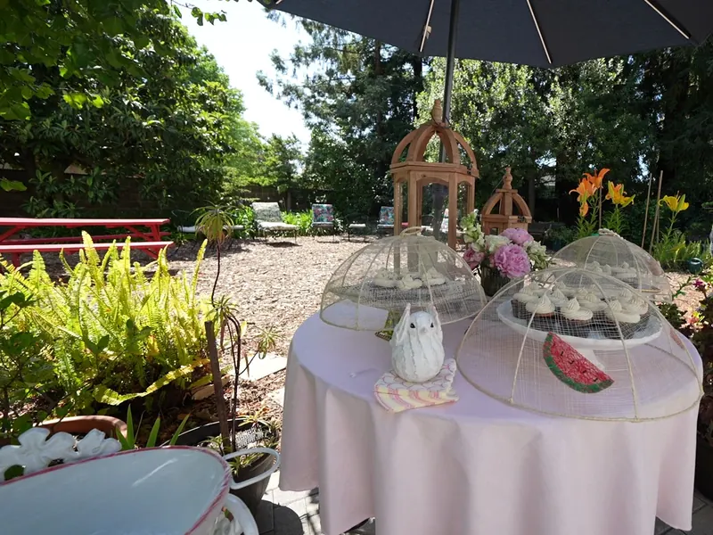 Dessert table under a garden umbrella with glass cloches at a Sunol country property