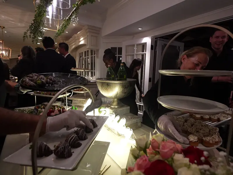 Tiered dessert table with chilled champagne and guests at a Castro Valley reception