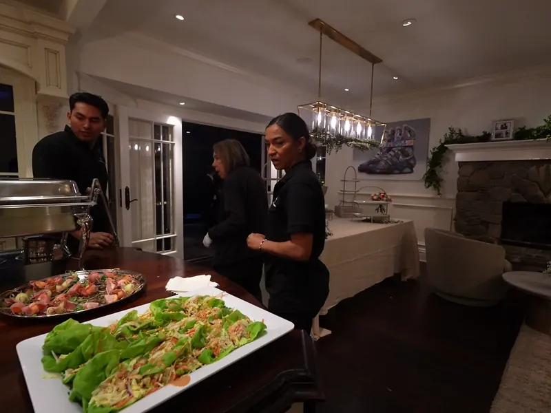 Catering team plating appetizer platters in the kitchen before a Dublin event
