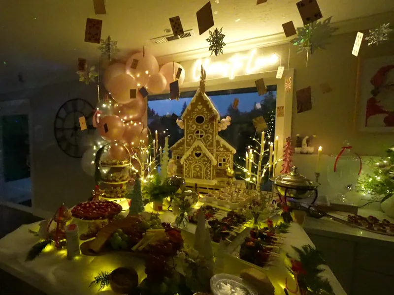 Warmly lit buffet with lantern centerpiece and balloons at a San Ramon celebration